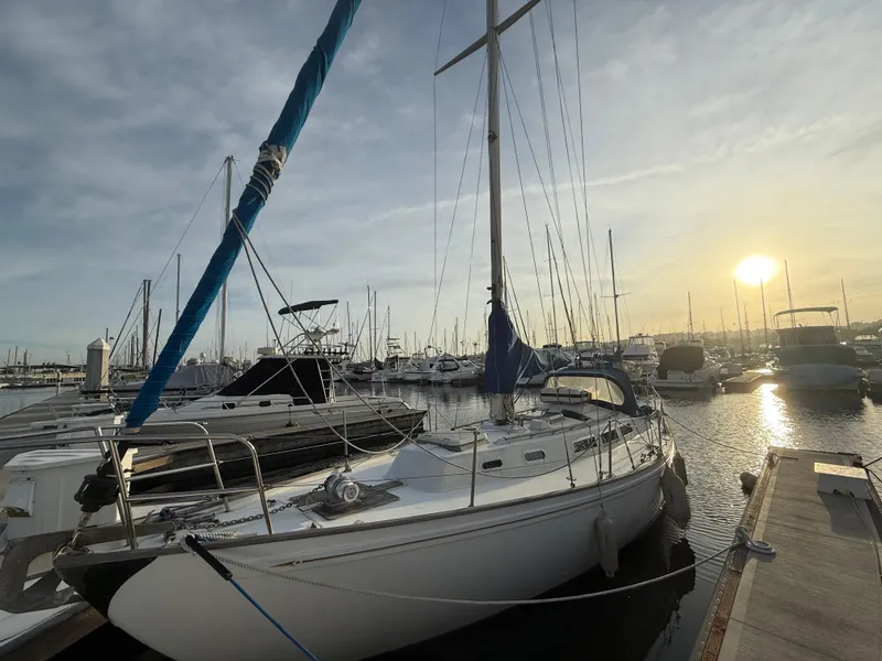 Slide: The Image of 1980 Rival 32 sailboat docked at sunset in marina. - 6
