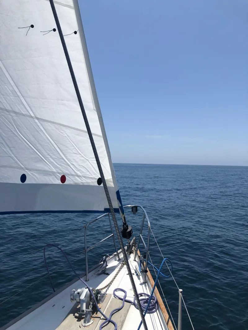 Slide: The Image of 1980 Rival 32 sailboat cruising on open sea. - 8