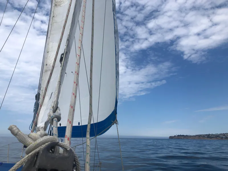 Slide: The Image of 1980 Rival 32 sailboat on calm sea under blue sky. - 9