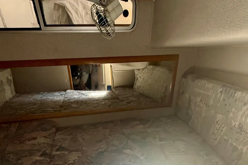 Slide: The Image of Interior cabin of a 1992 Sea Ray 290 Sundancer with patterned upholstery and a wall mirror. - 16