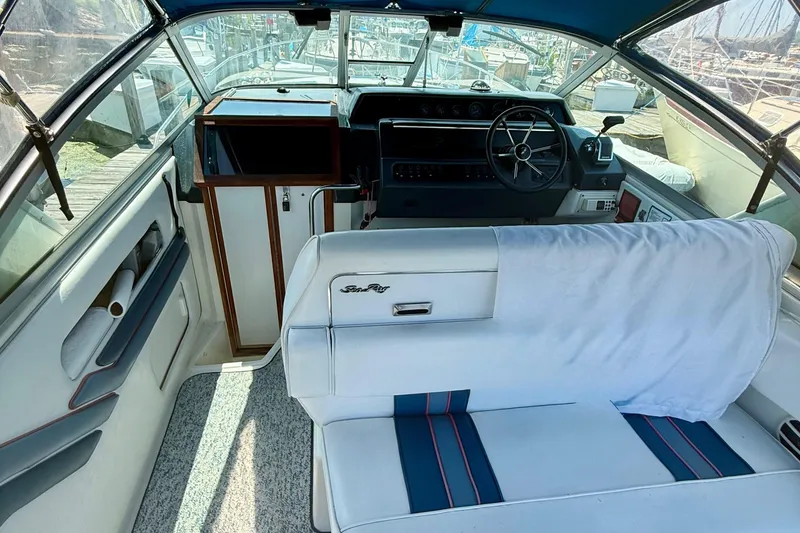 Slide: The Image of Interior of a 1992 Sea Ray 290 Sundancer boat with steering wheel and seating. - 5
