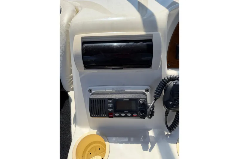 Slide: The Image of 2007 Silverton 33 Convertible boat dashboard with Uniden radio and cup holder. - 12