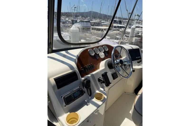 Slide: The Image of 2007 Silverton 33 Convertible boat cockpit with steering wheel and control panel. - 13