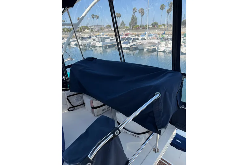 Slide: The Image of 2007 Silverton 33 Convertible boat interior with marina view, covered seating, and life jackets. - 18
