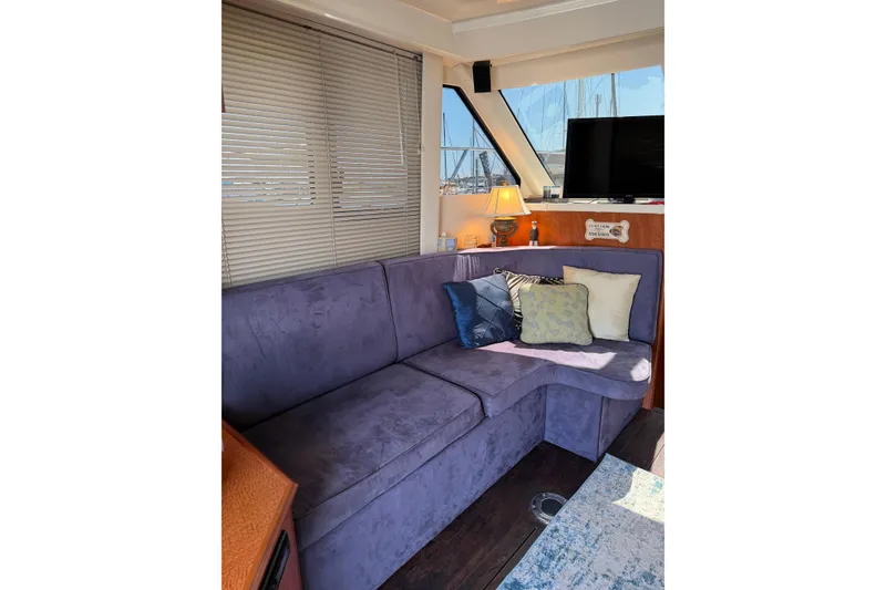 Slide: The Image of Interior of 2007 Silverton 33 Convertible yacht with plush seating and decorative pillows. - 20