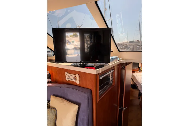 Slide: The Image of Interior of a 2007 Silverton 33 Convertible yacht with TV and cozy seating area. - 22