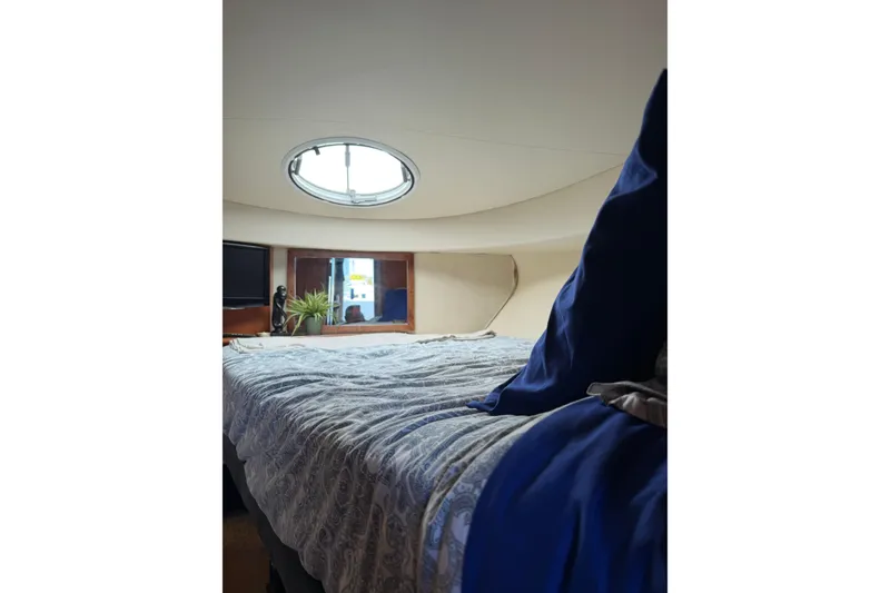 Slide: The Image of Interior cabin of 2007 Silverton 33 Convertible yacht with bed and porthole. - 23