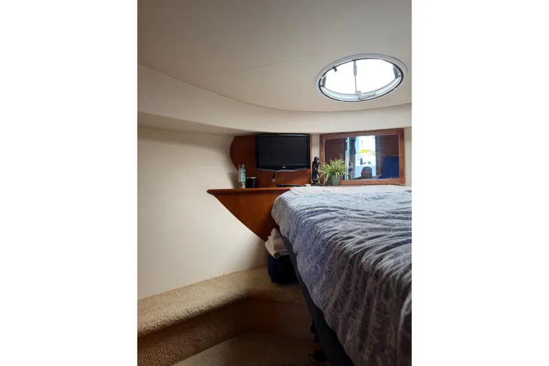 Slide: The Image of Interior cabin of 2007 Silverton 33 Convertible yacht with bed, window, and TV. - 24