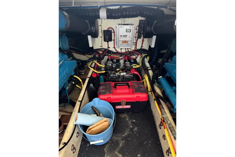 Slide: The Image of Engine room of a 2007 Silverton 33 Convertible boat with tools and wiring. - 28