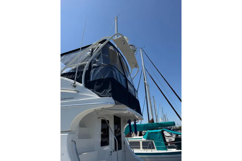 Slide: The Image of 2007 Silverton 33 Convertible yacht docked under clear blue sky. - 5