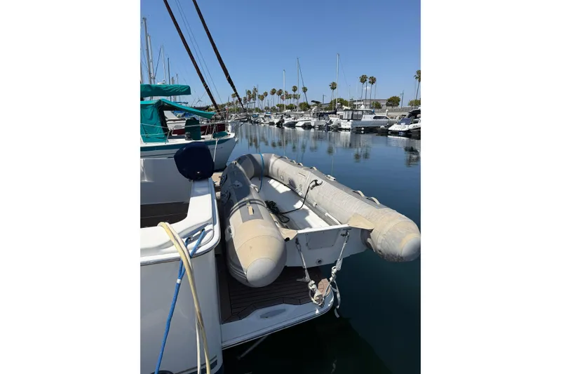 Slide: The Image of 2007 Silverton 33 Convertible yacht with inflatable dinghy in marina. - 6