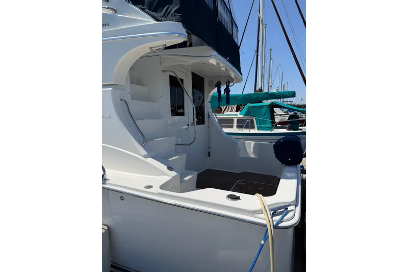 Slide: The Image of 2007 Silverton 33 Convertible yacht docked, showcasing sleek design and spacious deck area. - 7
