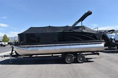 The Image of 2026 Lowe SF 214 Sport Fish pontoon boat with black cover on trailer. - 0