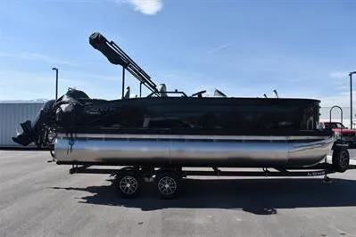 Slide: The Image of 2026 Lowe SF 214 Sport Fish pontoon boat on trailer, parked outdoors. - 10