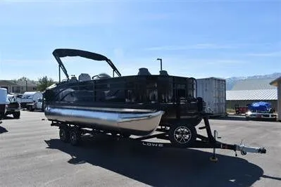 Slide: The Image of 2026 Lowe SF 214 Sport Fish pontoon boat on trailer in sunny outdoor setting. - 11