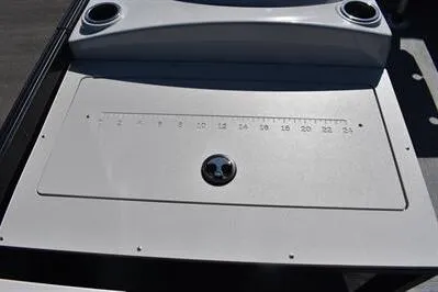 Slide: The Image of 2026 Lowe SF 214 Sport Fish boat dashboard with measurement markings and cup holders. - 22