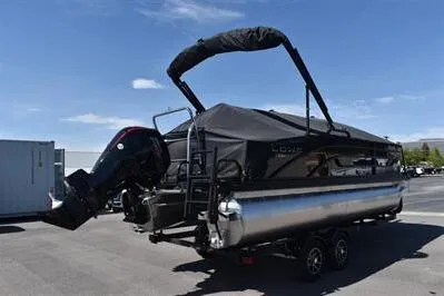 Slide: The Image of 2026 Lowe SF 214 Sport Fish pontoon boat on trailer, covered and ready for transport. - 3
