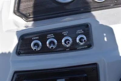 Slide: The Image of Control panel of 2026 Lowe SF 214 Sport Fish boat with switches for stereo and lights. - 35