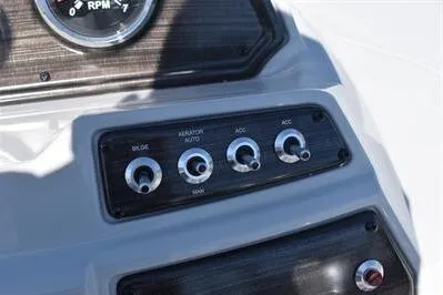 Slide: The Image of Control panel of 2026 Lowe SF 214 Sport Fish boat with switches and RPM gauge. - 37