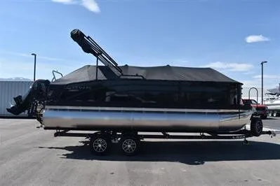 Slide: The Image of 2026 Lowe SF 214 Sport Fish pontoon boat on trailer, covered and parked outdoors. - 4