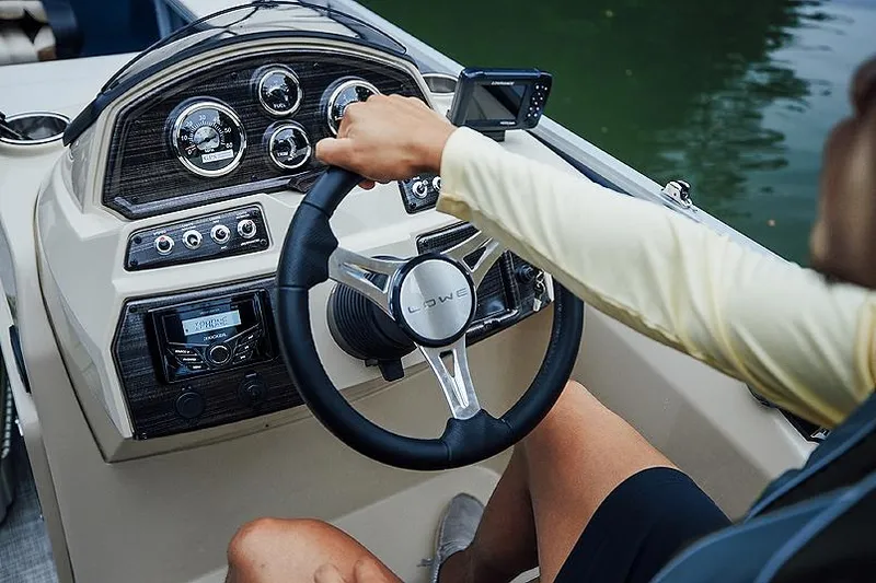 Slide: The Image of Manufacturer Provided Image: Person steering 2025 Lowe SF 214 boat, dashboard with gauges and controls visible. - 45