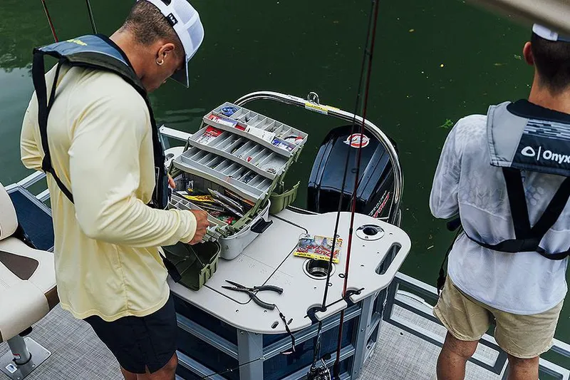 Slide: The Image of Manufacturer Provided Image: Two people fishing on a 2025 Lowe SF 214 boat, organizing tackle box. - 47