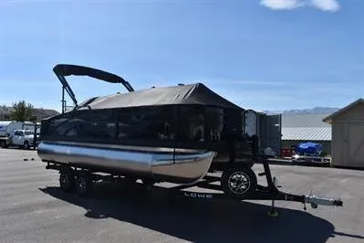Slide: The Image of 2026 Lowe SF 214 Sport Fish pontoon boat on trailer in sunny parking lot. - 5