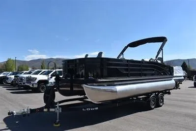Slide: The Image of 2026 Lowe SF 214 Sport Fish pontoon boat on trailer in parking lot. - 6