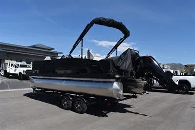 Slide: The Image of 2026 Lowe SF 214 Sport Fish pontoon boat on trailer, parked outdoors. - 8
