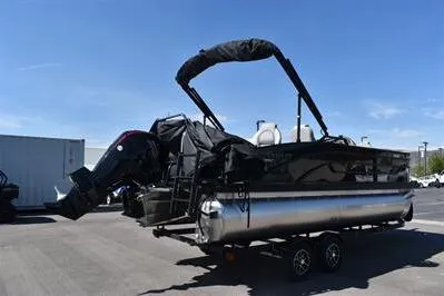 Slide: The Image of 2026 Lowe SF 214 Sport Fish pontoon boat on trailer, parked outdoors. - 9