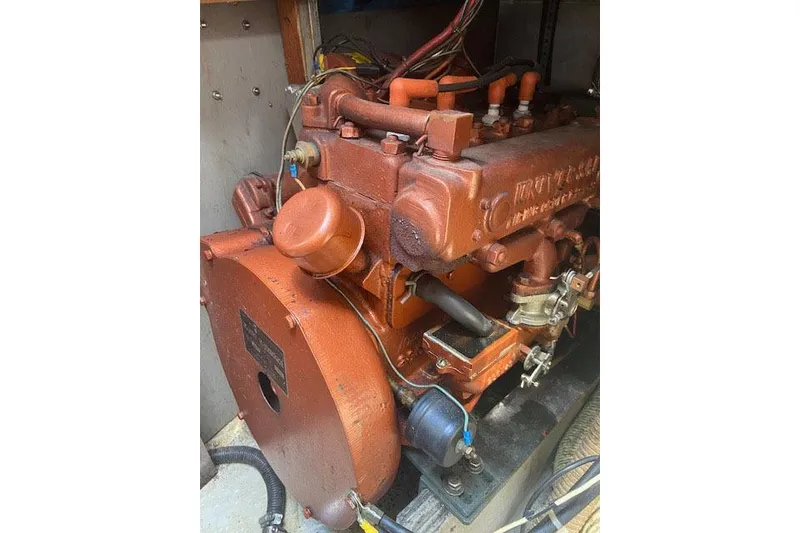 Slide: The Image of 1977 C&C 29 engine, vintage marine motor with visible wiring and components. - 14