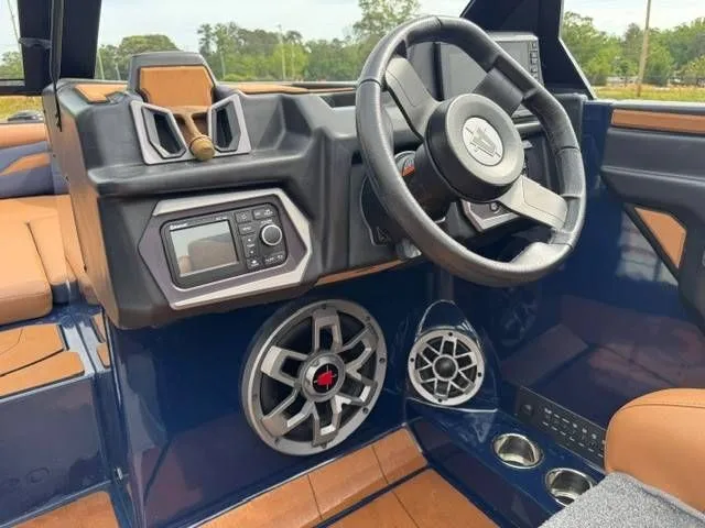 Slide: The Image of Interior of 2023 Axis Wake Research T250 boat with steering wheel and speakers. - 10