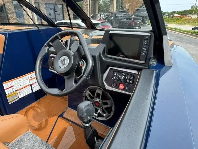 Slide: The Image of Interior of 2023 Axis Wake Research T250 boat with steering wheel and electronics. - 14