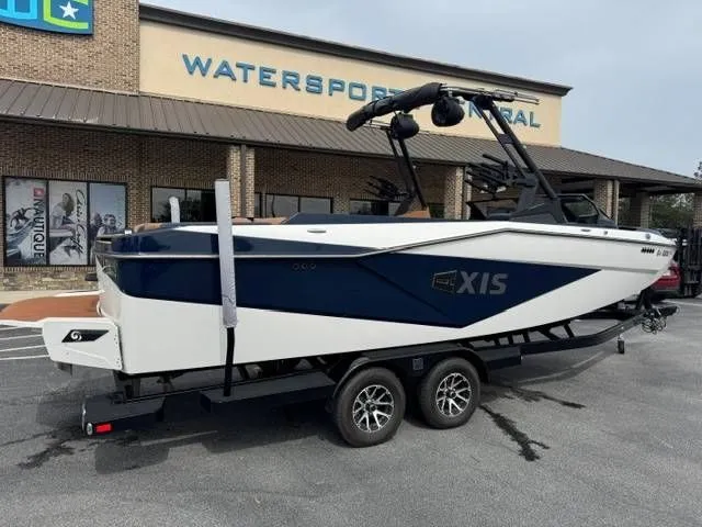 Slide: The Image of 2023 Axis Wake Research T250 boat outside watersports store. - 15