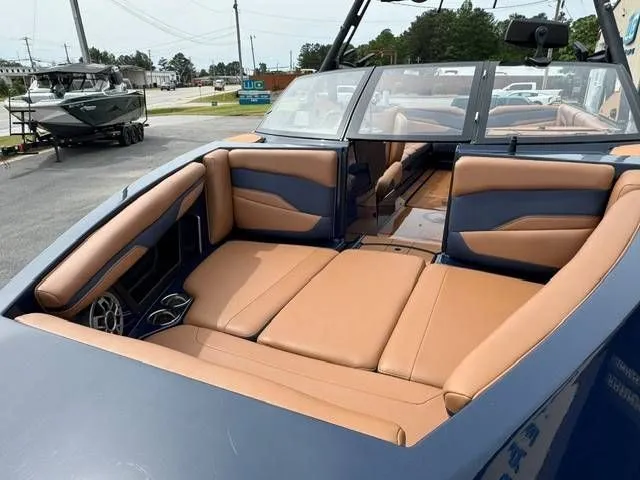 Slide: The Image of Interior of a 2023 Axis Wake Research T250 boat with brown seating. - 16