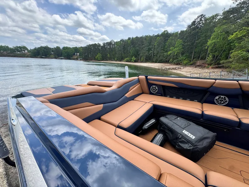 Slide: The Image of 2023 Axis Wake Research T250 boat at lakeside with cloudy sky. - 18