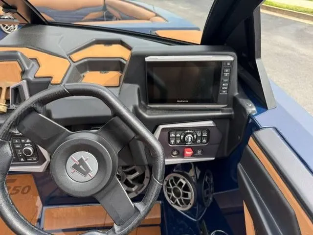 Slide: The Image of Interior of 2023 Axis Wake Research T250 boat with steering wheel and control console. - 5