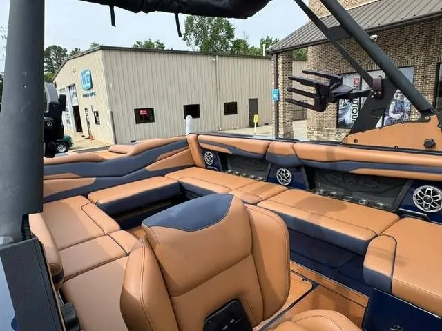 Slide: The Image of Interior of a 2023 Axis Wake Research T250 boat with brown leather seats. - 8