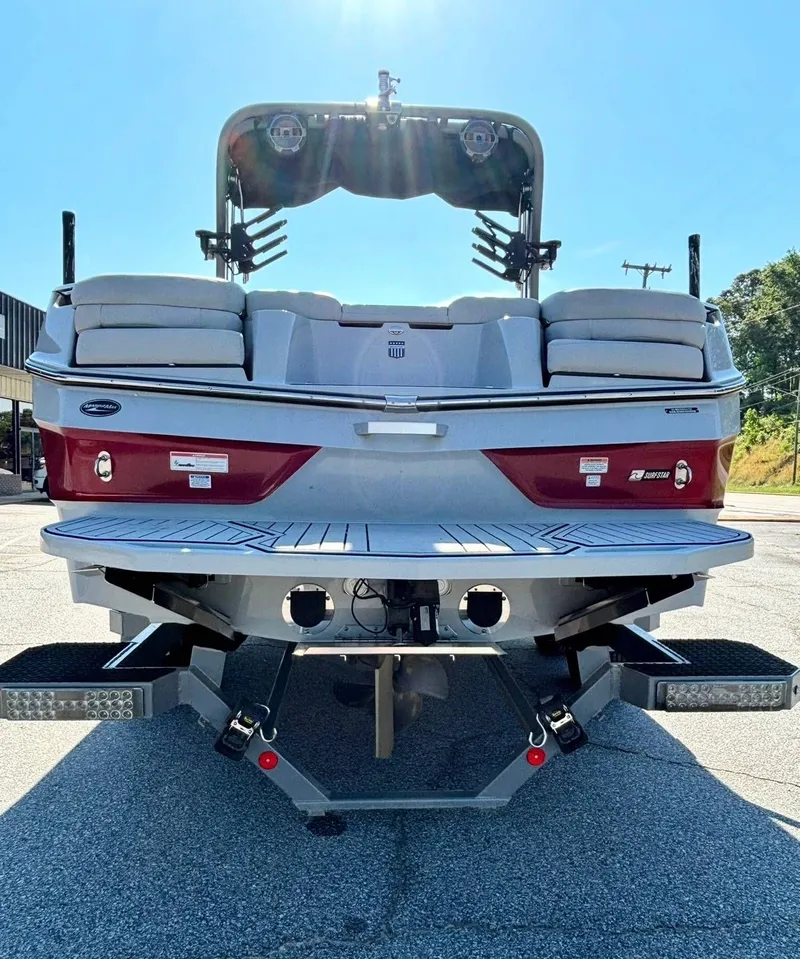 Slide: The Image of Rear view of a 2022 MasterCraft XT23 boat on a parking lot. - 15