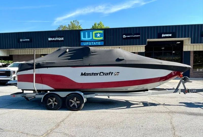 Slide: The Image of 2022 MasterCraft XT23 boat with cover on trailer. - 3