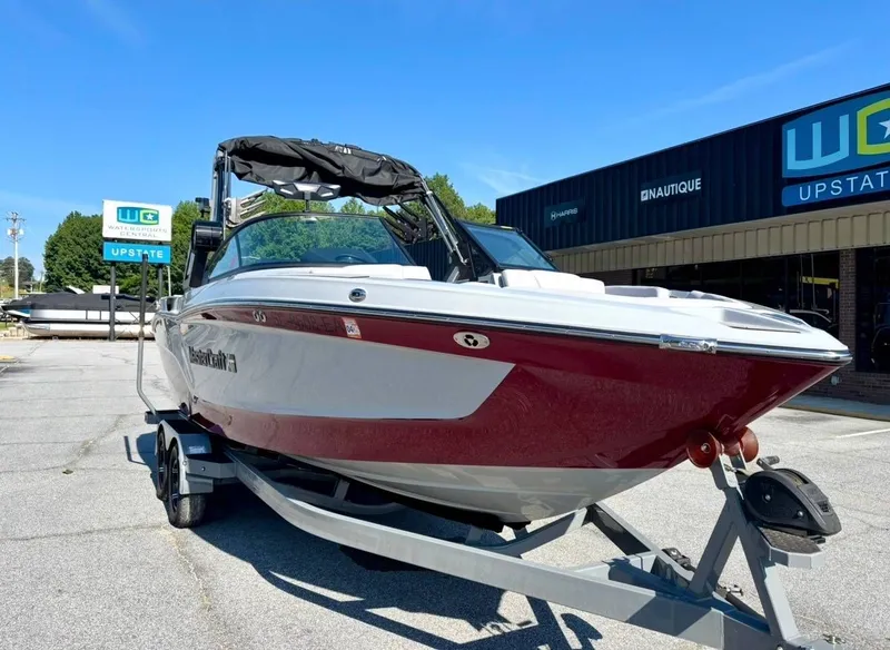 Slide: The Image of 2022 MasterCraft XT23 boat on trailer at watersports center. - 4