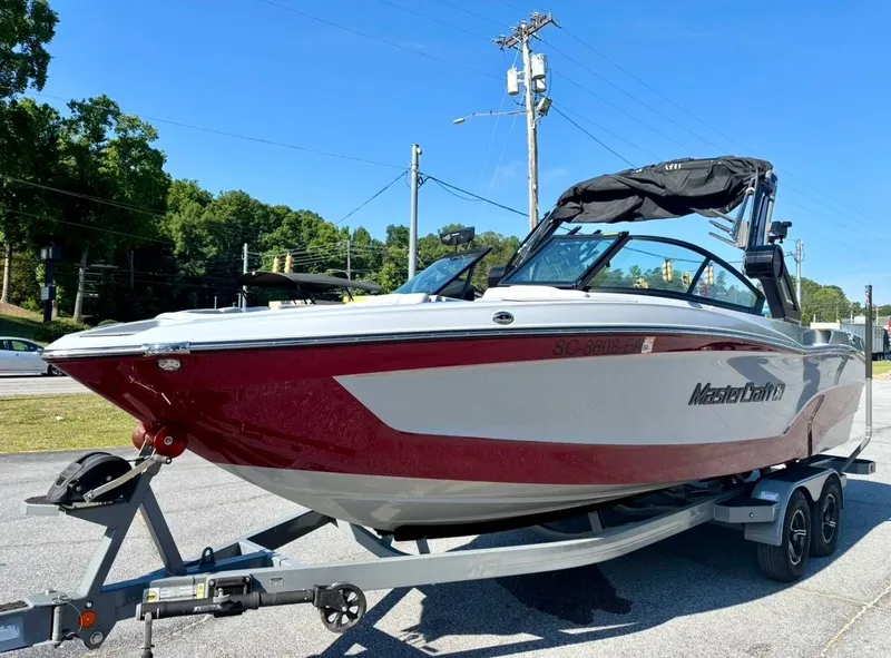 Slide: The Image of 2022 MasterCraft XT23 boat on trailer, red and white design. - 5