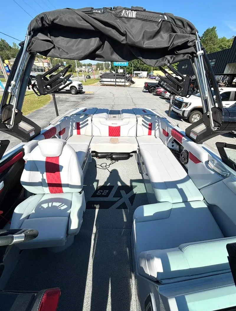 Slide: The Image of Interior of a 2022 MasterCraft XT23 boat with red accents. - 8