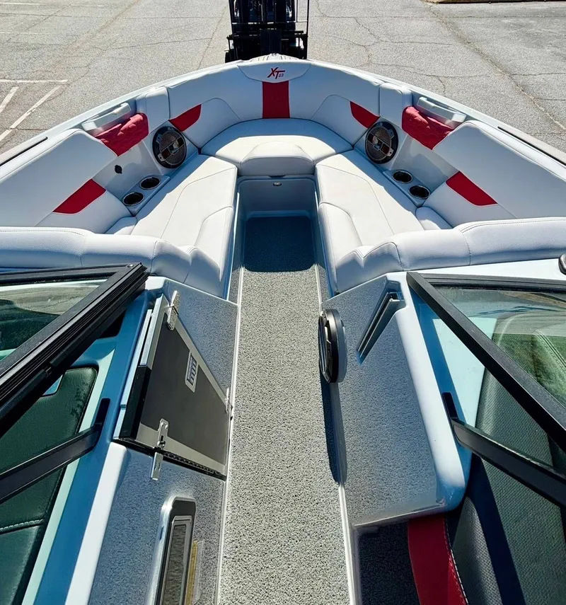 Slide: The Image of Interior of 2022 MasterCraft XT23 boat with white and red seating. - 9
