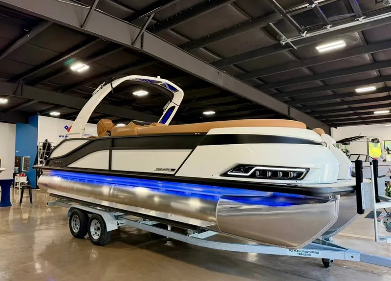 Slide: The Image of 2026 Harris Grand Mariner 250 on trailer in indoor showroom. - 2