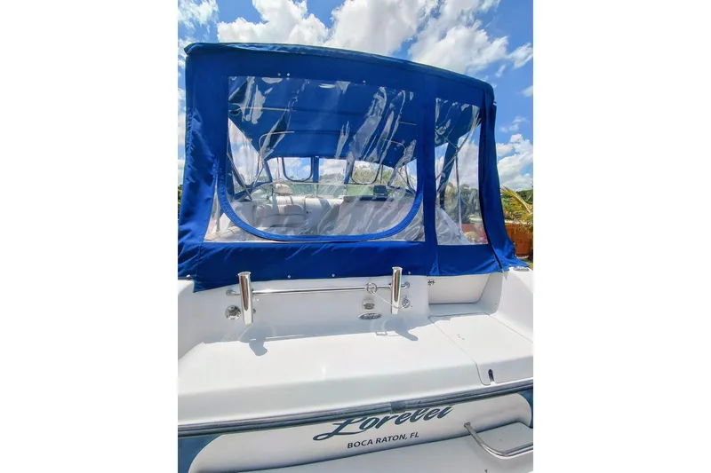 Slide: The Image of 2000 Crownline 242 CR boat with blue canopy, docked in Boca Raton, FL. - 10