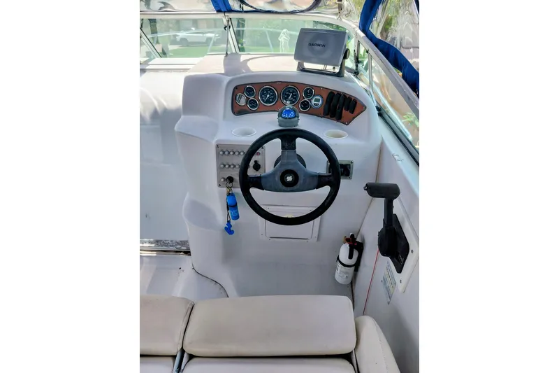 Slide: The Image of Cockpit of 2000 Crownline 242 CR boat with steering wheel and navigation equipment. - 12
