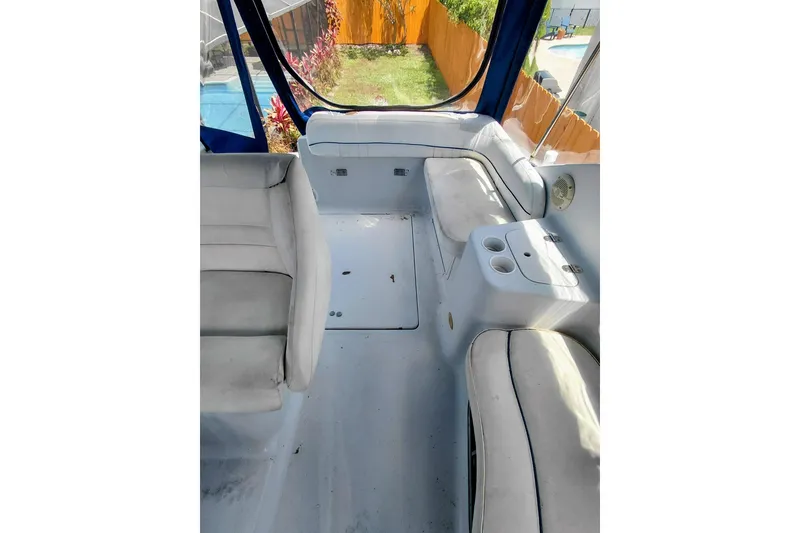 Slide: The Image of Interior of 2000 Crownline 242 CR boat with white seating and cup holders. - 13