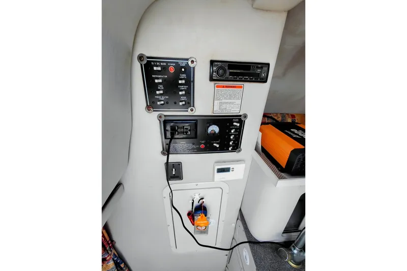 Slide: The Image of Control panel of a 2000 Crownline 242 CR boat, featuring various switches and outlets. - 15