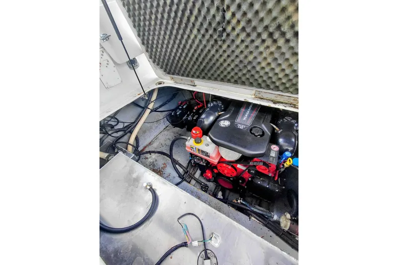 Slide: The Image of Engine compartment of a 2000 Crownline 242 CR boat, showcasing mechanical components. - 17